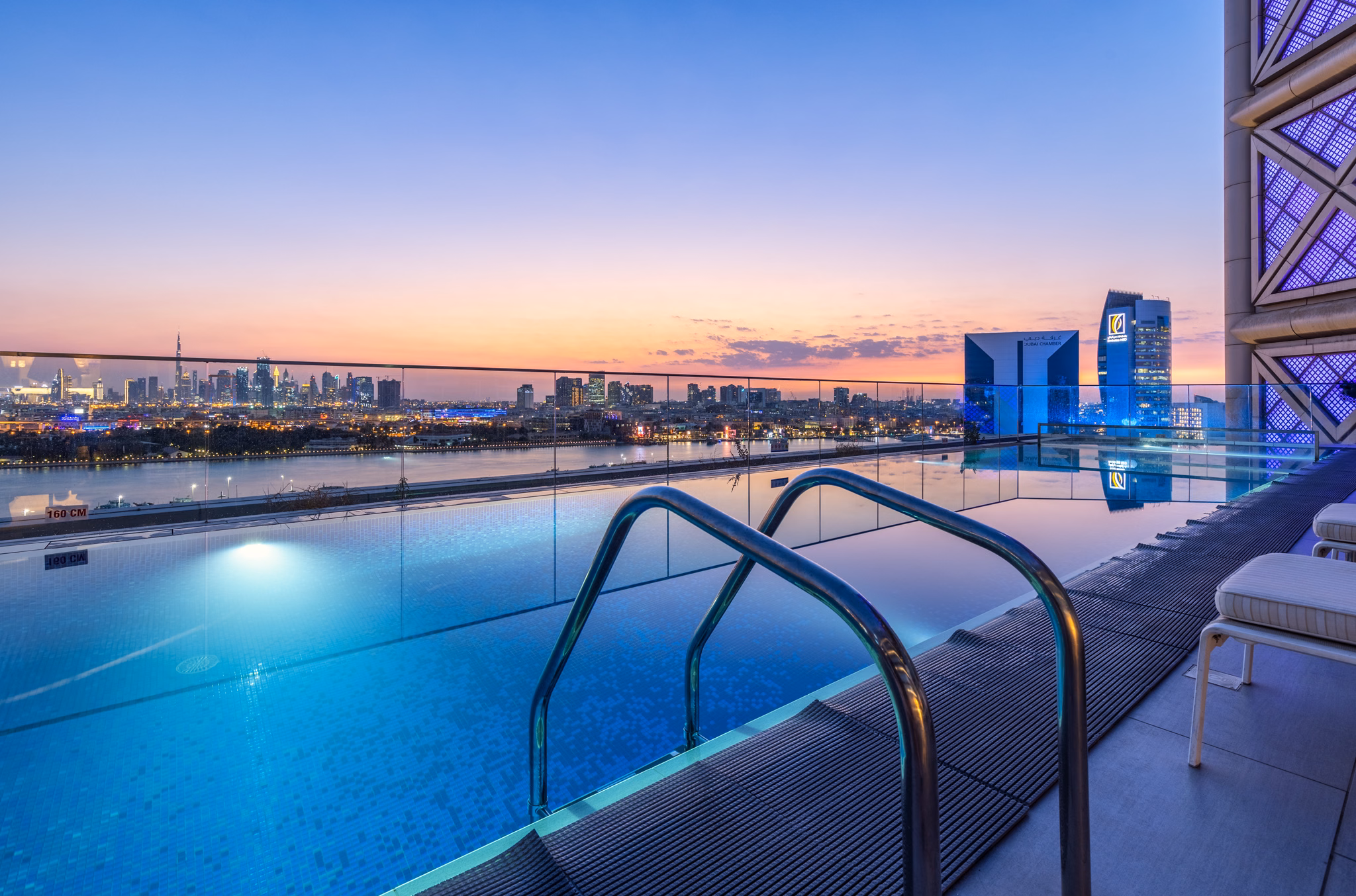 Rooftop pool and skyline at night at Al Bandar Rotana in Dubai Creek, UAE