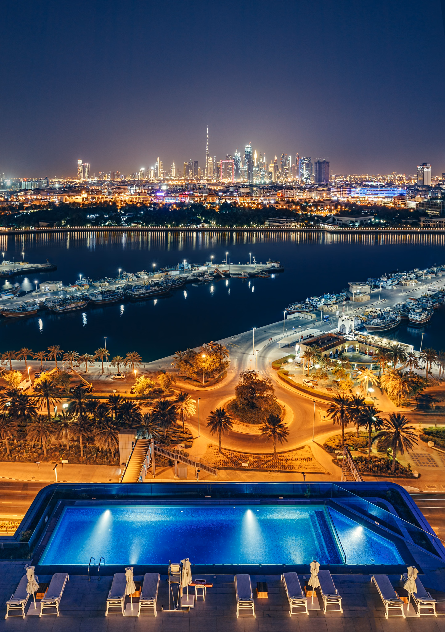 Rooftop pool and Dubai skyline at night at Al Bandar Rotana in Dubai Creek, UAE