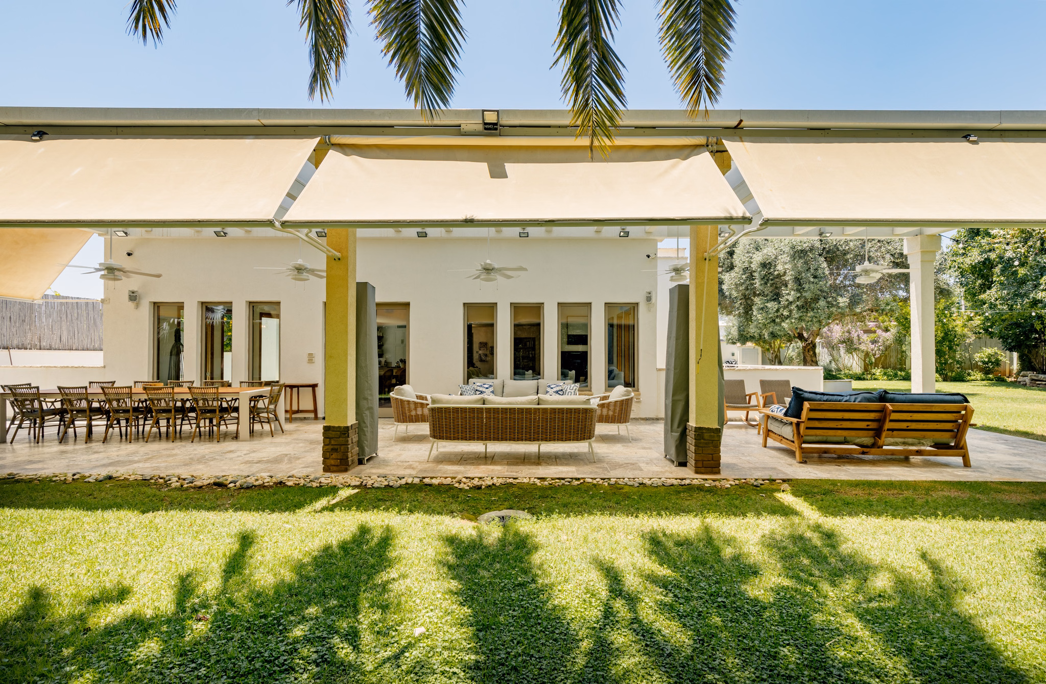 Rear garden facade and covered veranda at Villa Hod HaSharon in Hod HaSharon, Israel