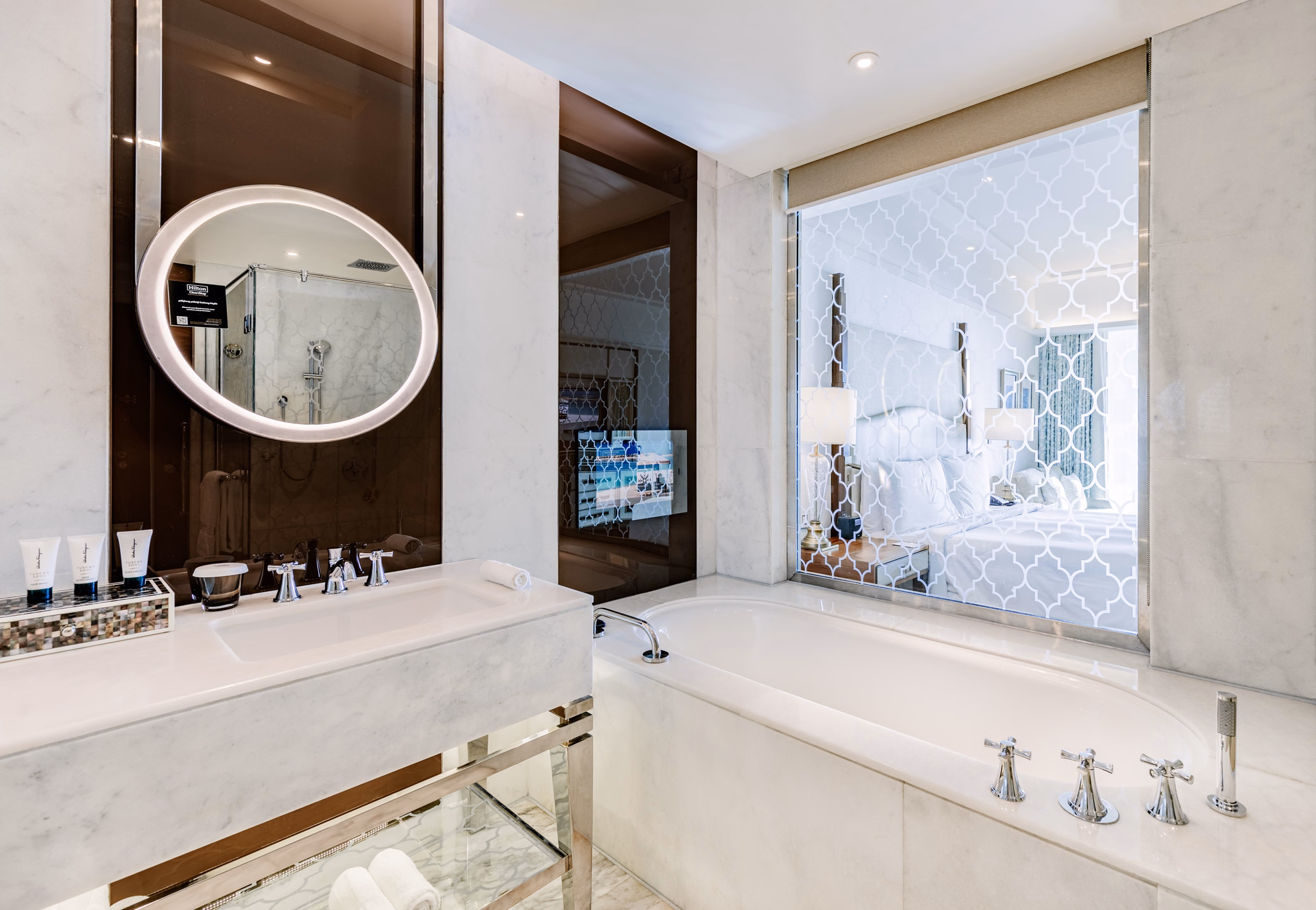 Marble bathroom vanity viewed toward the bedroom at Waldorf Astoria Dubai Palm Jumeirah in Dubai, UAE