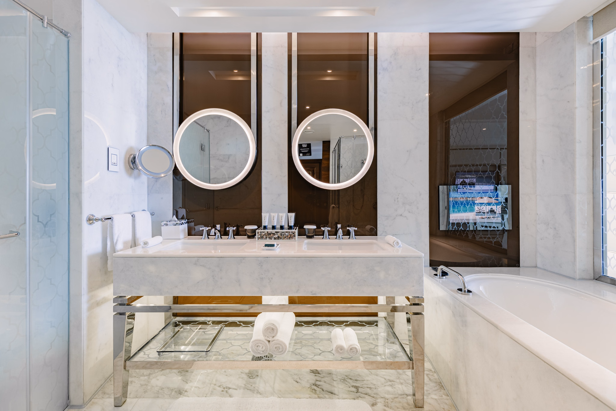 Symmetrical double-vanity marble bathroom at Waldorf Astoria Dubai Palm Jumeirah in Dubai, UAE
