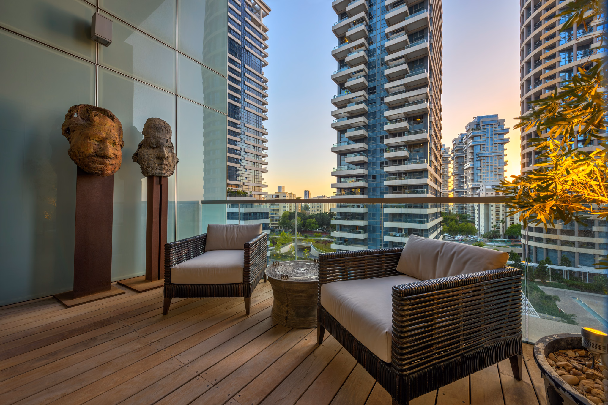Furnished NAM Tower balcony framed by sculptures and residential towers in Tel Aviv
