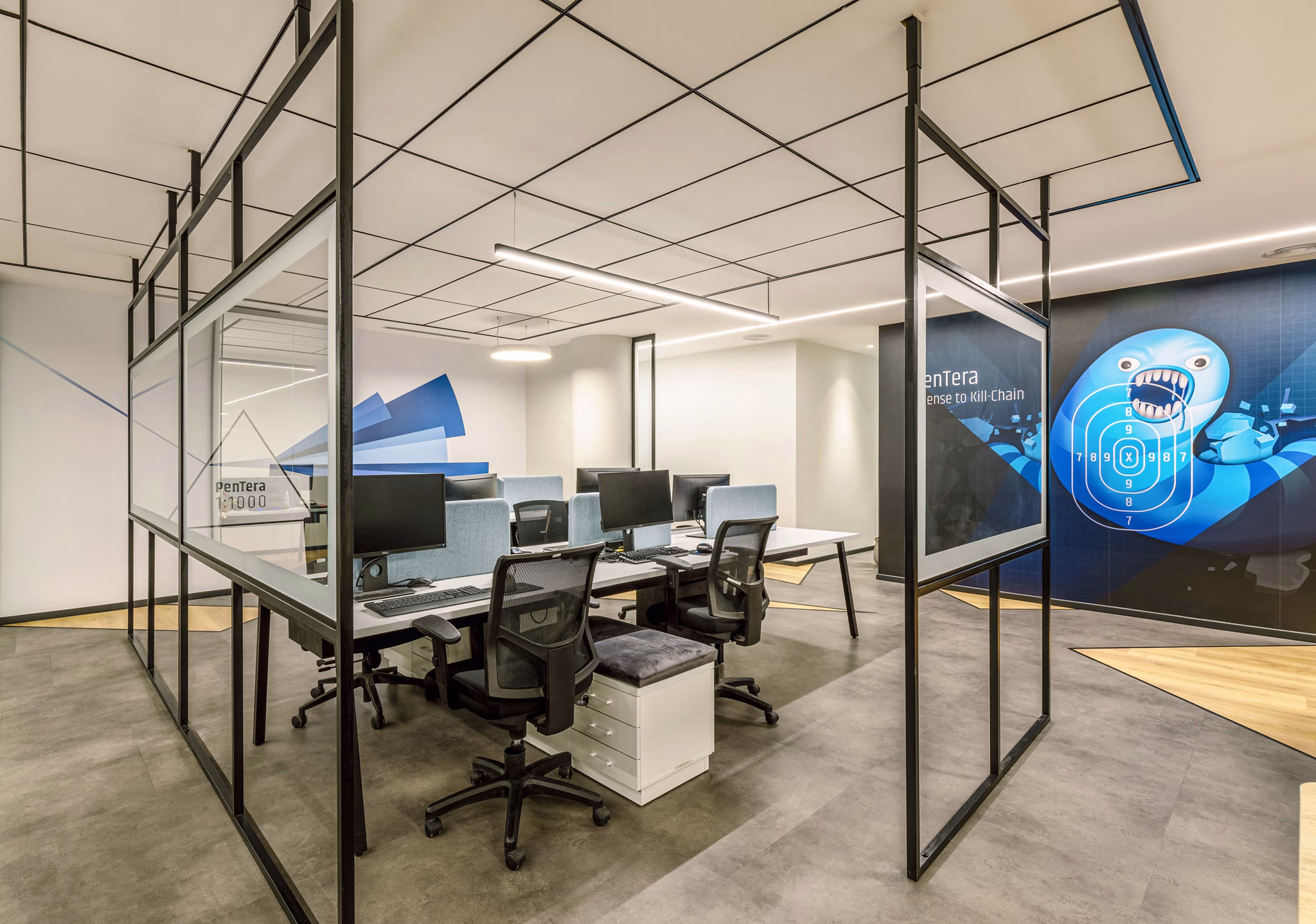 Open-plan workspace with digital display at PCYSYS Offices in Petah Tikva, Israel